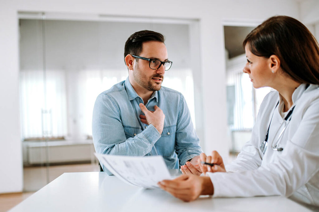 man talking with doctor about chronic pain and opioids