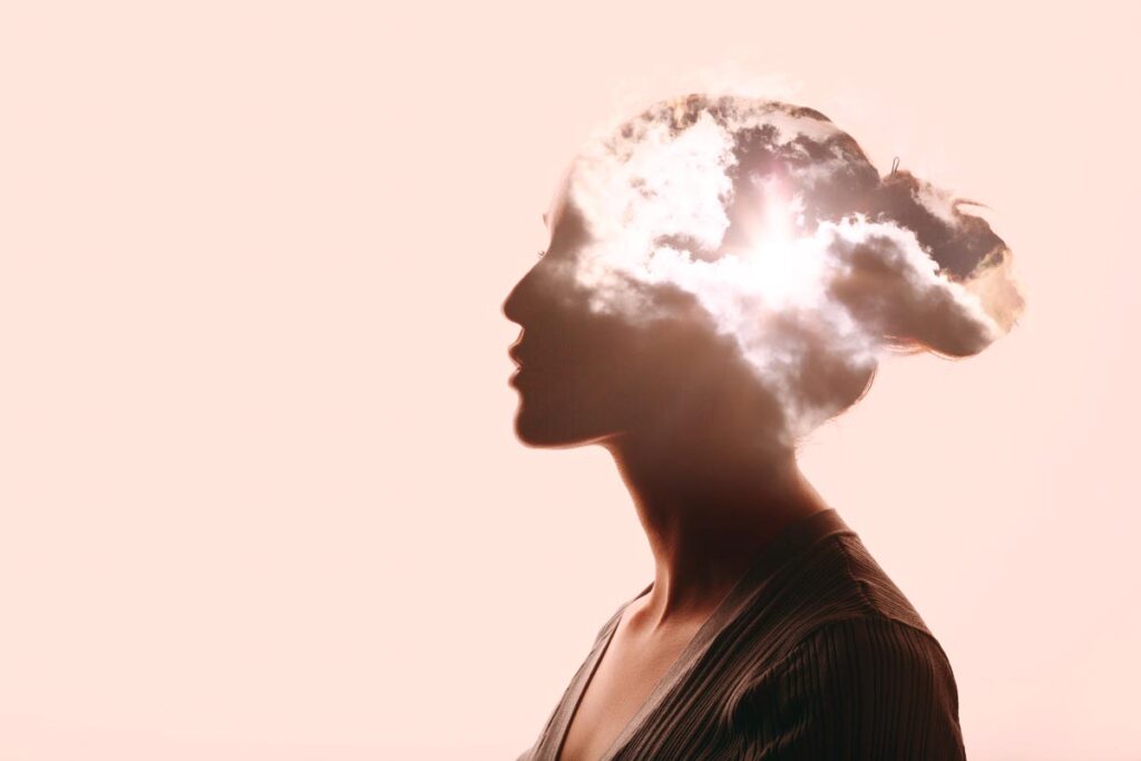 woman with clouds in place of her brain thinks about mental health and addiction