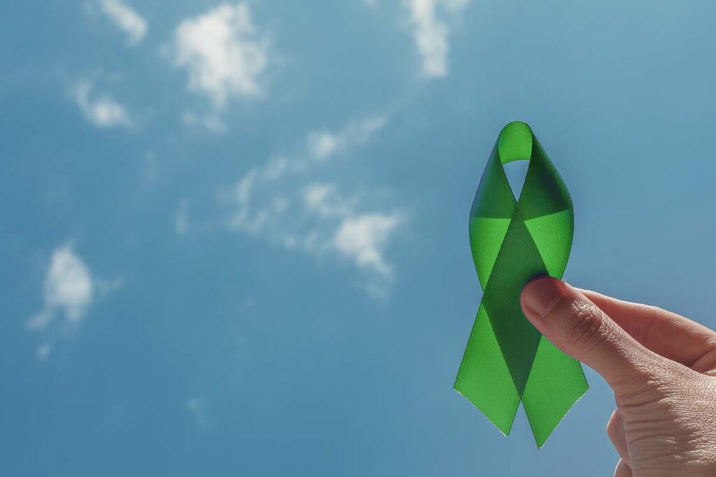 a person holds a ribbon to symbolize world mental health day