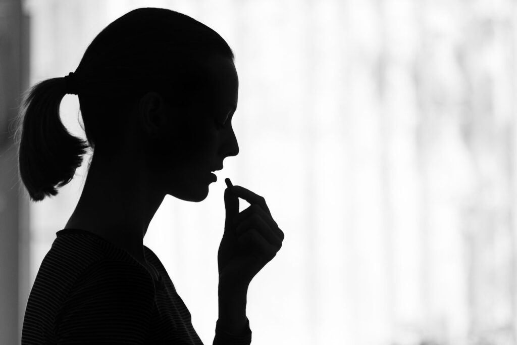 Silhouette of a person experiencing symptoms of OxyContin addiction