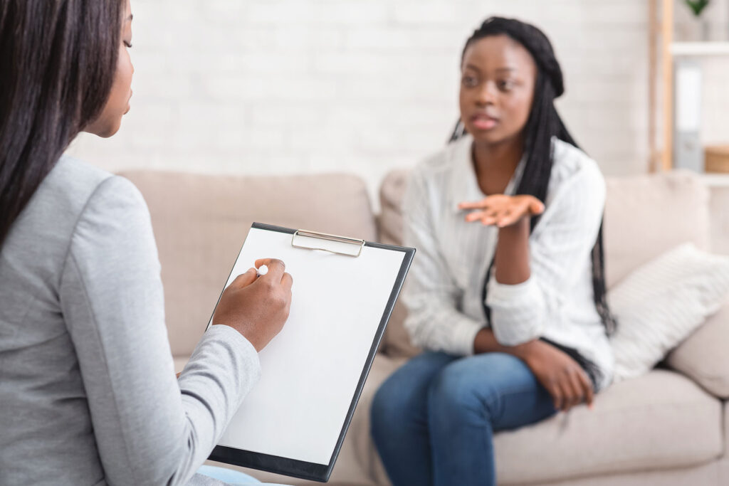 Woman describing symptoms to counselor in outpatient mental health treatment