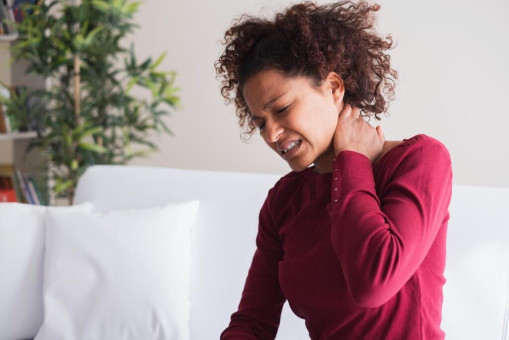 woman holding neck and thinking about what is pain management