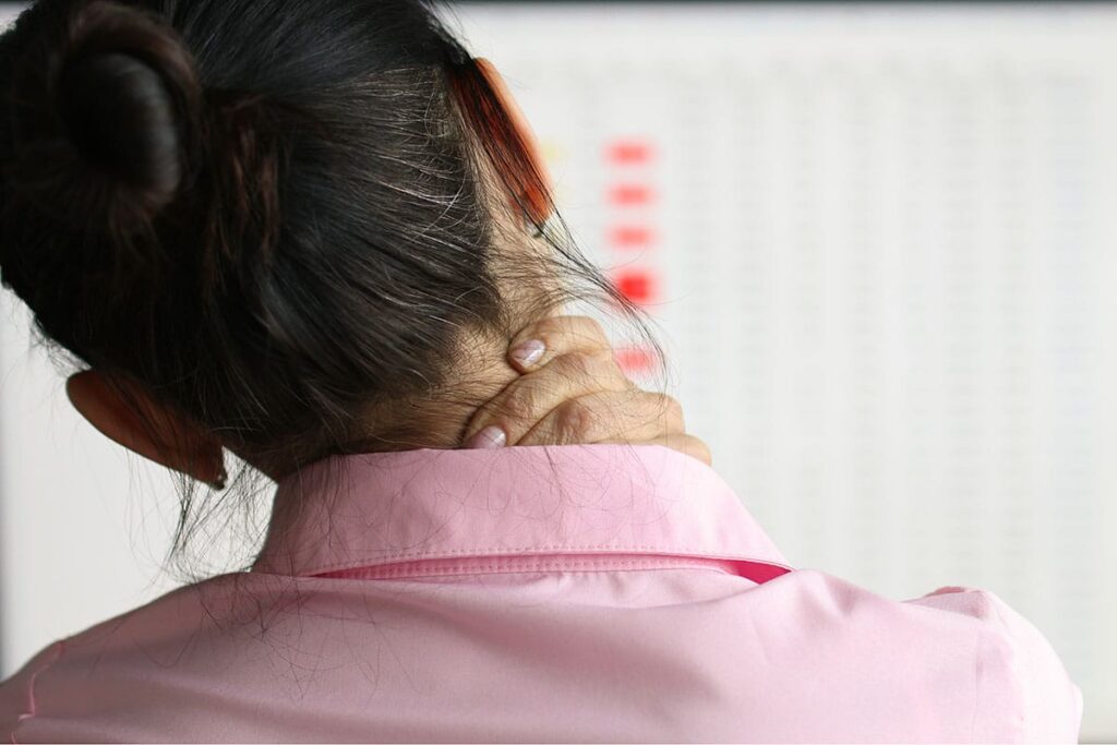 woman in pink shirt with neck pain wondering what is pain management