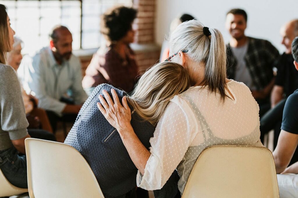 woman encourages other woman about the importance of group therapy