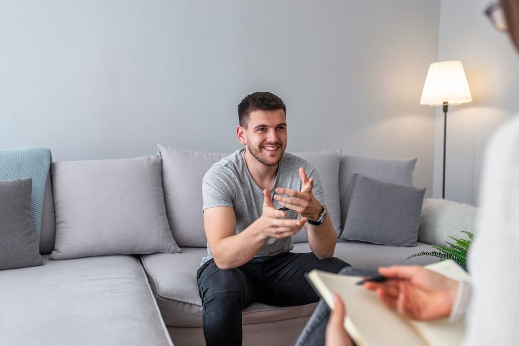 man on couch talks with therapist about treatment goals for depression