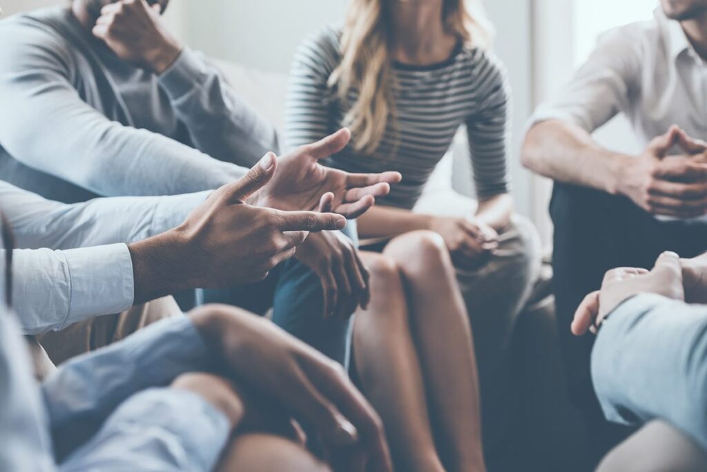 people in a group session discuss fun ideas for group therapy